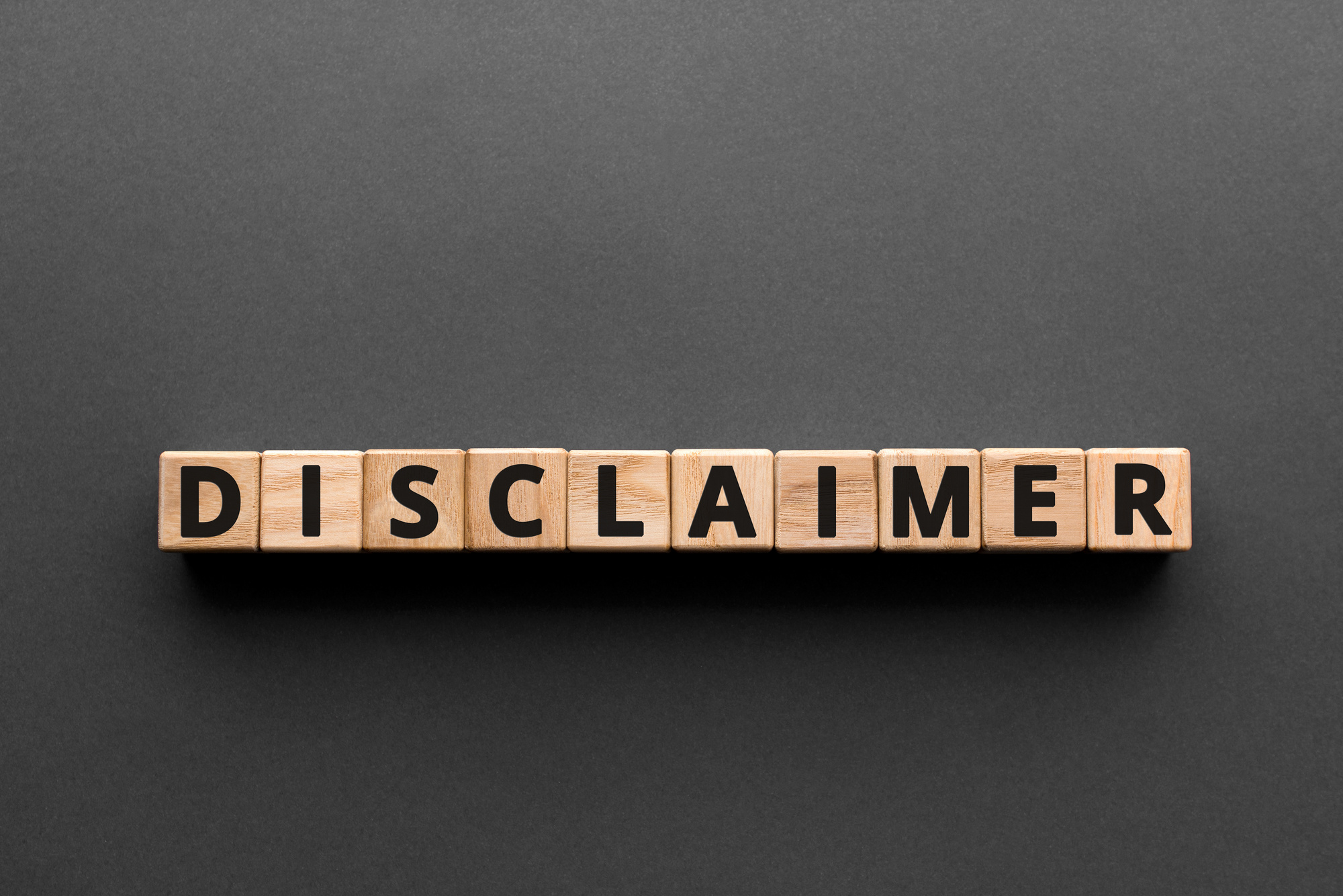 Disclaimer - words from wooden blocks with letters